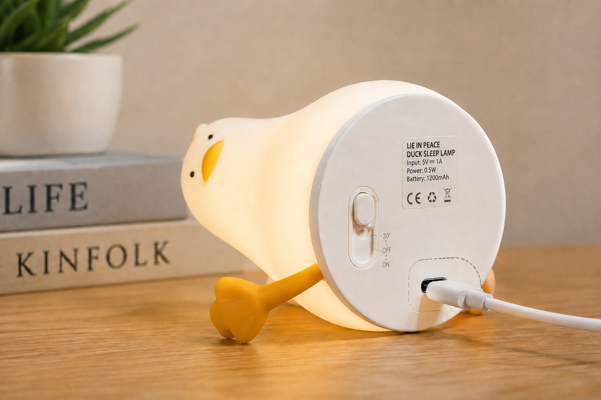 Base of the duck night light showing a connected charging cable and a switch marked ON, OFF and 30 minutes
