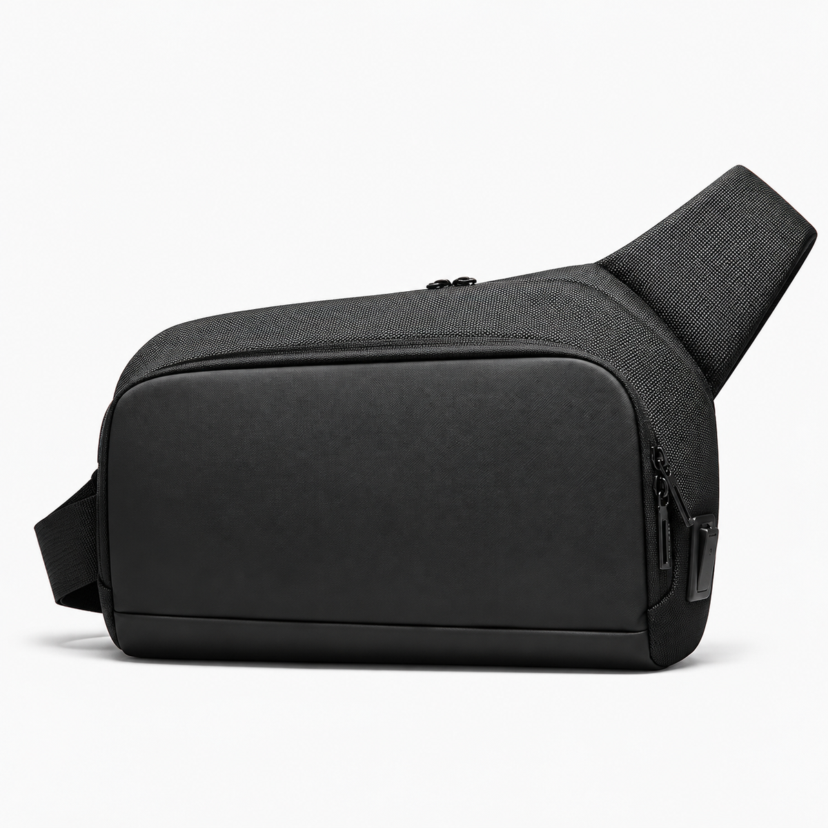 Black Oxford crossbody sling bag with a smooth front panel, zippered compartments and wide shoulder strap on a white background