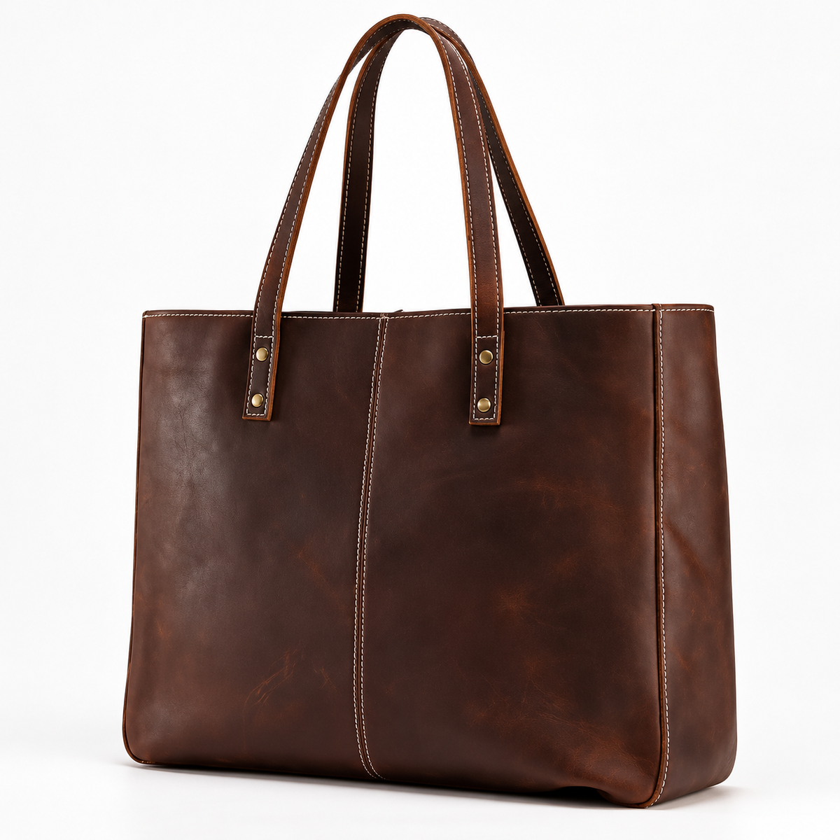 Reddish brown leather tote bag shown at an angle with two handles, contrast stitching and a rectangular base