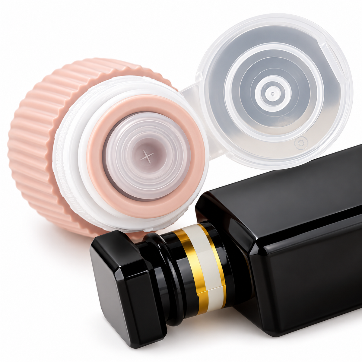 Close-up of a peach silicone travel bottle showing a cross-slit dispensing valve beneath an open clear flip-top cap