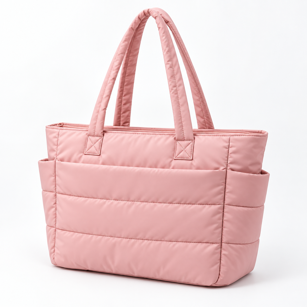 Pink quilted nylon tote bag showing horizontal stitching, long shoulder straps and a zip-top closure
