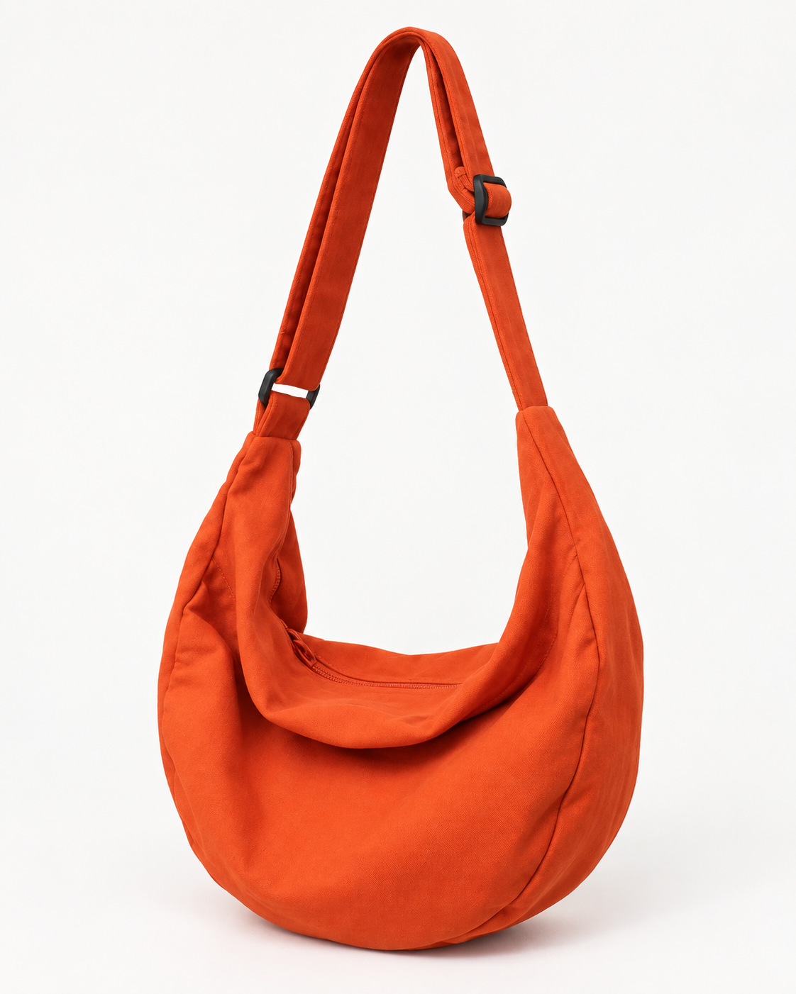 Orange hobo shoulder bag with a wide adjustable strap and zip closure on a white background