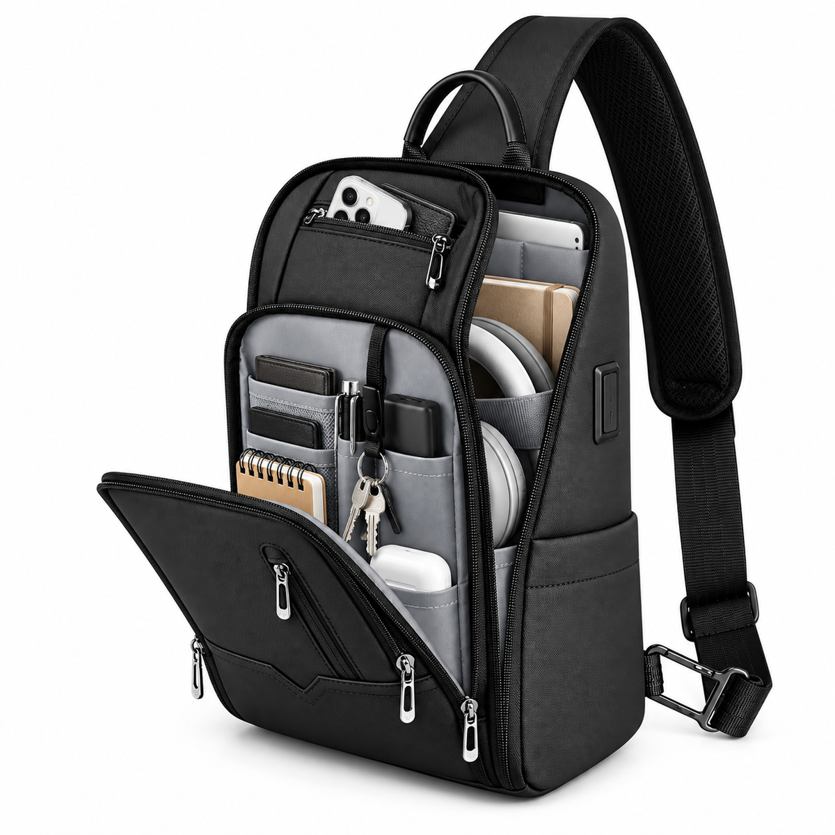 Open black crossbody bag showing a tablet, phone, headphones, wallet and keys organized in separate compartments