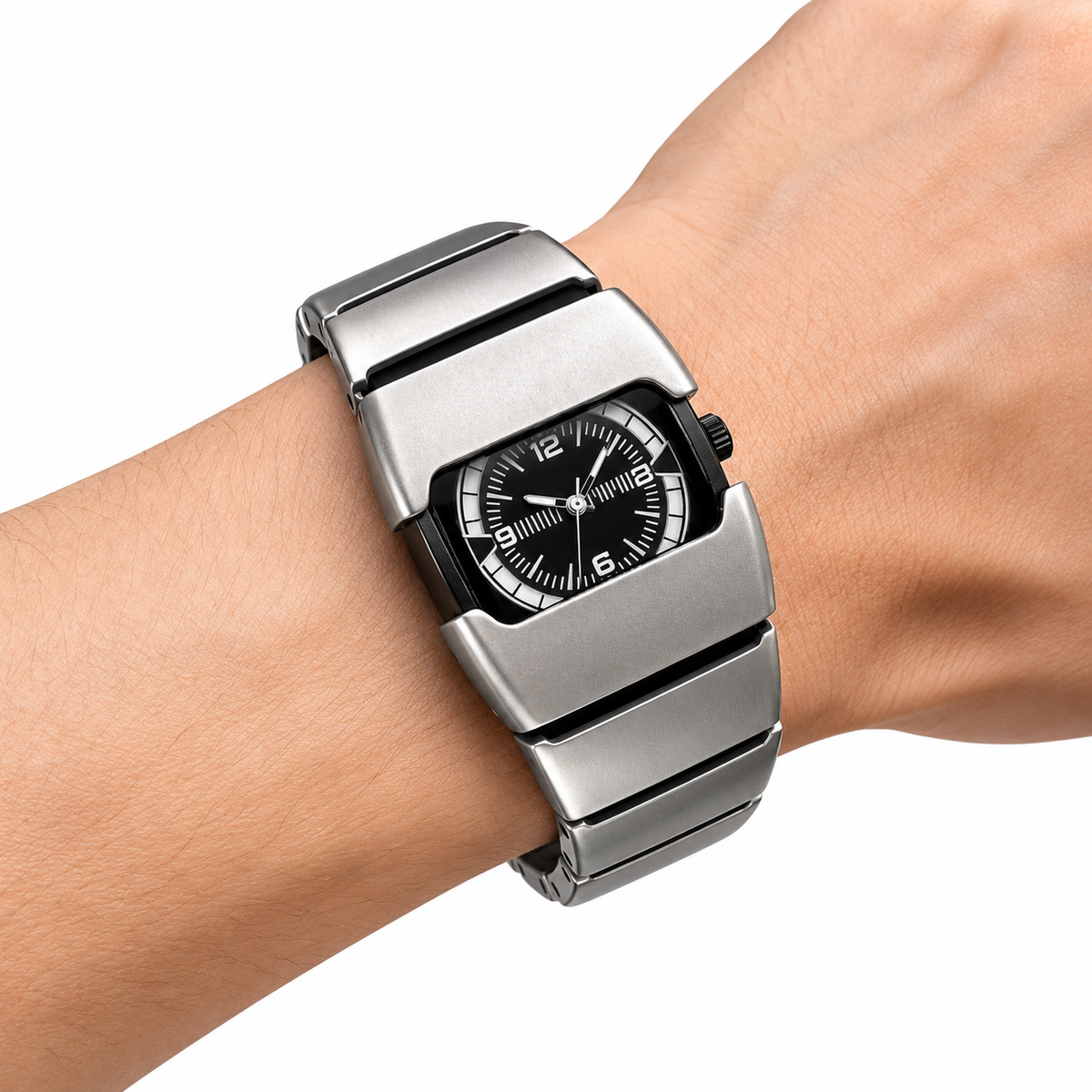 Silver-colored analog wristwatch worn on a wrist, with a black numbered dial and wide segmented bracelet